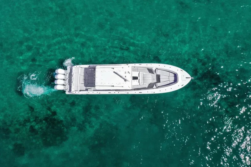  Yacht Photos Pics Aerial view of 2024 HCB 53 Suenos yacht cruising in clear turquoise waters.