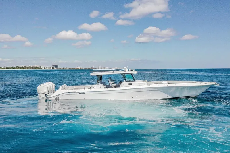  Yacht Photos Pics 2024 HCB 53 Suenos luxury boat cruising on clear blue ocean waters.