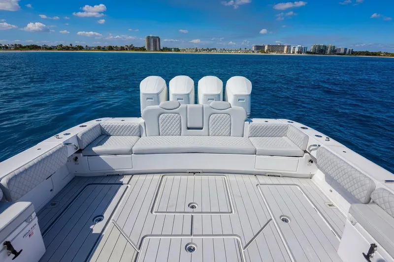  Yacht Photos Pics 2024 HCB 53 Suenos luxury boat deck with seating, ocean view, and clear sky.