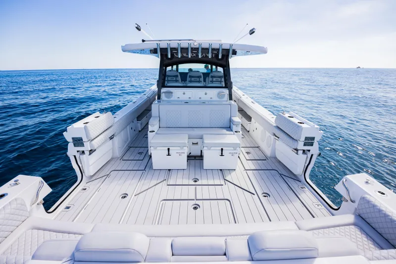  Yacht Photos Pics 2024 HCB 53 Suenos luxury boat deck on open sea, showcasing spacious seating and sleek design.