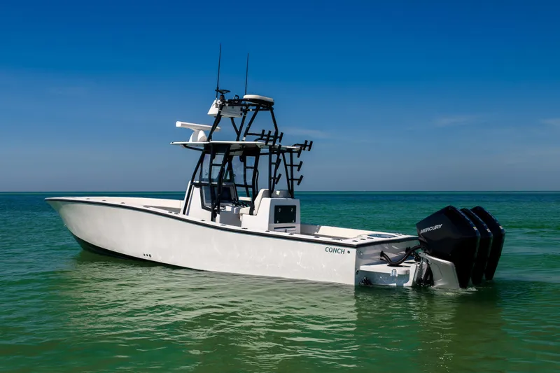  Yacht Photos Pics 2025 Conch 33 boat on clear turquoise water under blue sky.