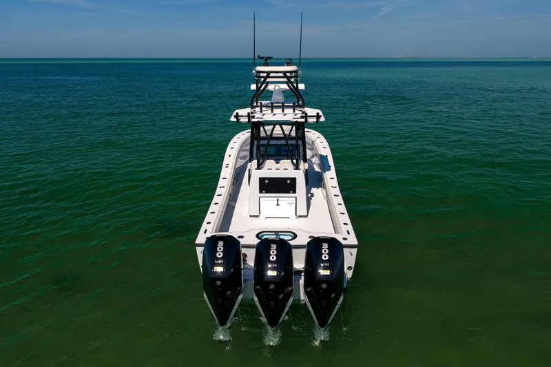  Yacht Photos Pics 2025 Conch 33 boat with triple engines on open water.