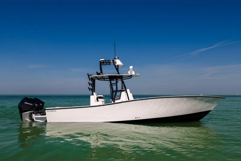  Yacht Photos Pics 2025 Conch 33 boat on calm sea under clear blue sky.