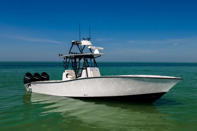  Yacht Photos Pics 2025 Conch 33 boat on clear turquoise water under blue sky.