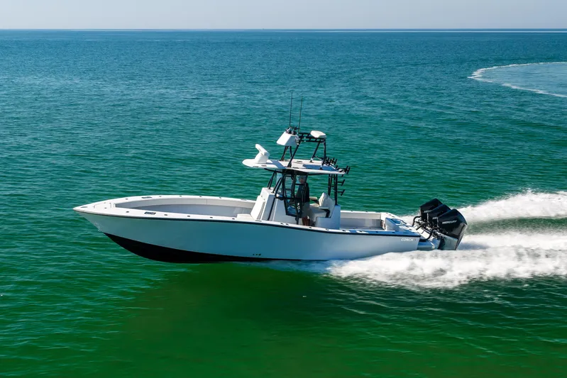 Yacht Photos Pics 2025 Conch 33 boat cruising on open water, showcasing sleek design and powerful engines.