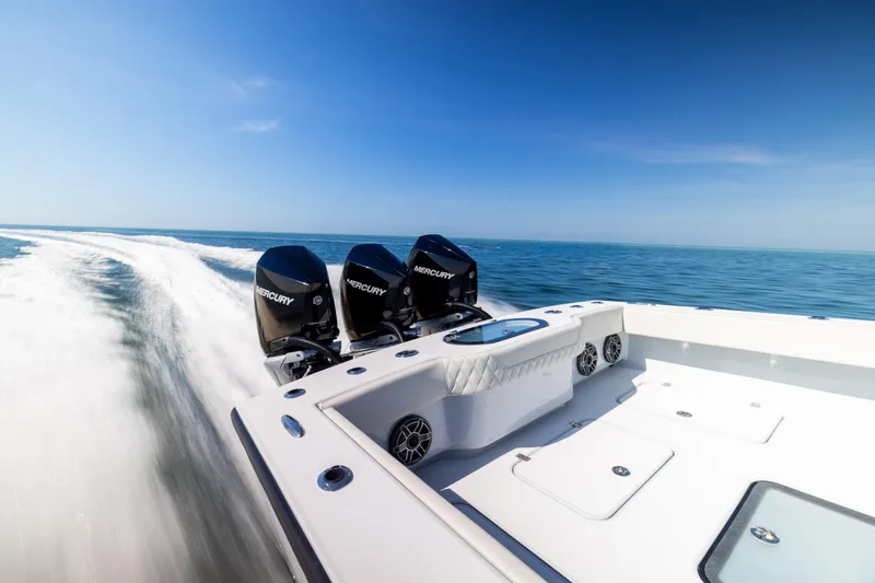  Yacht Photos Pics 2025 Conch 33 boat with triple Mercury engines cruising on open water.