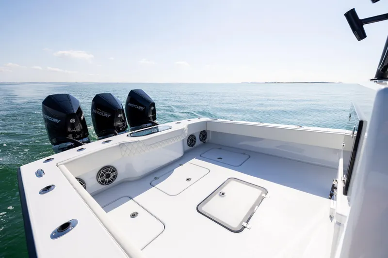  Yacht Photos Pics 2025 Conch 33 boat with triple Mercury engines on open sea.