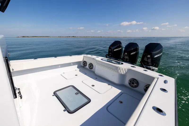  Yacht Photos Pics 2025 Conch 33 boat with triple Mercury engines on calm ocean waters.