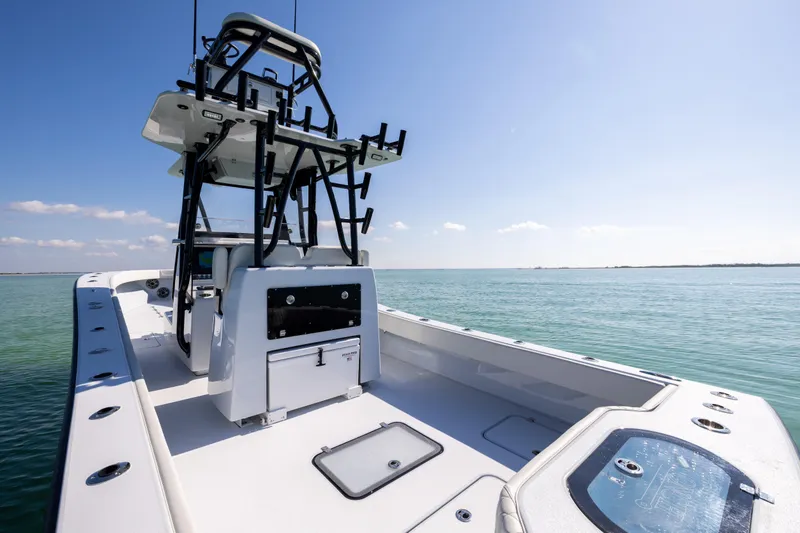 Yacht Photos Pics 2025 Conch 33 boat on calm ocean waters under clear blue sky.