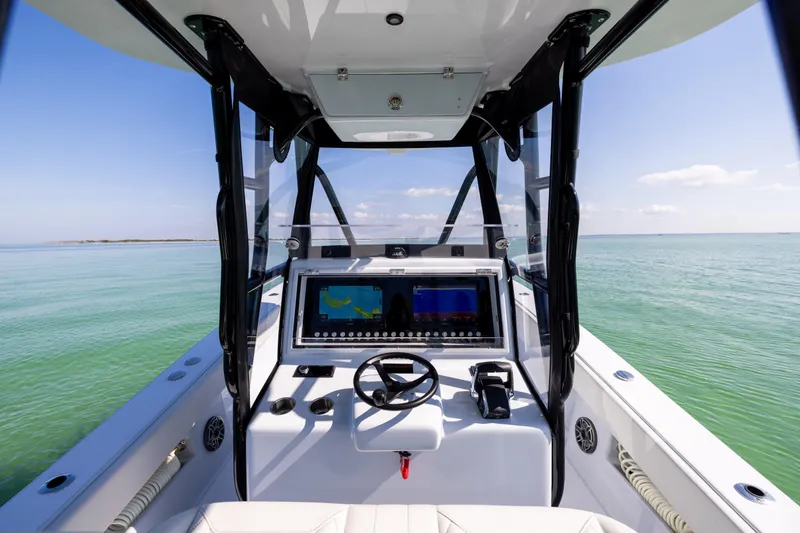  Yacht Photos Pics 2025 Conch 33 boat cockpit with advanced navigation system on calm sea.