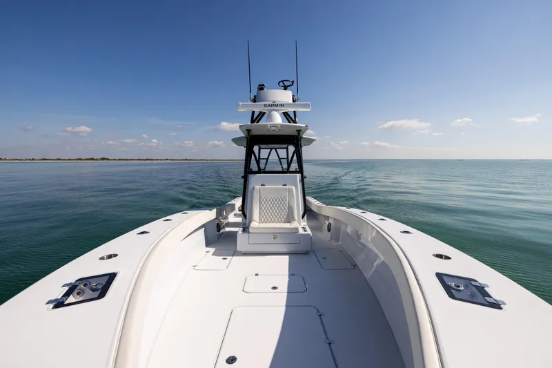  Yacht Photos Pics 2025 Conch 33 boat cruising on calm ocean waters under clear blue sky.