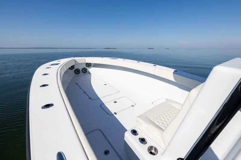  Yacht Photos Pics 2025 Conch 33 boat on calm water, featuring sleek white deck and seating.