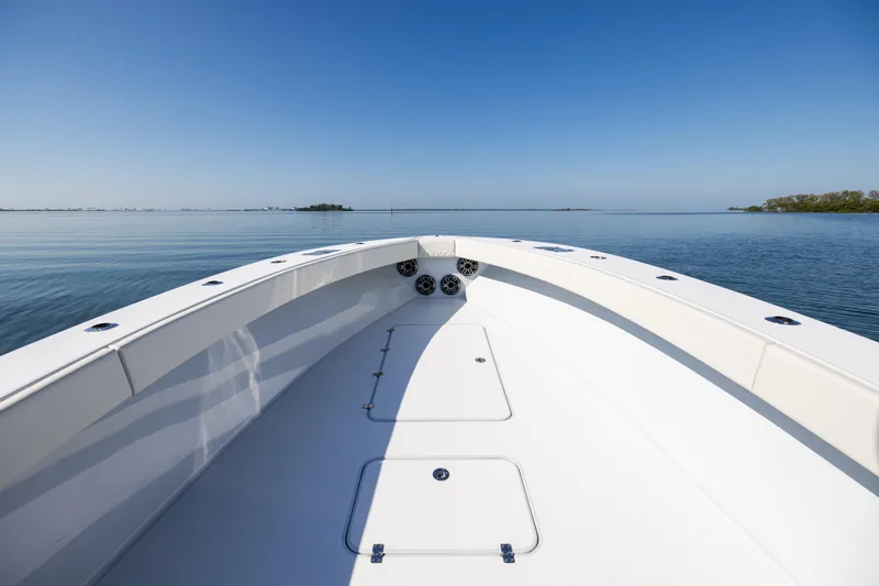  Yacht Photos Pics 2025 Conch 33 boat on calm water under clear blue sky.