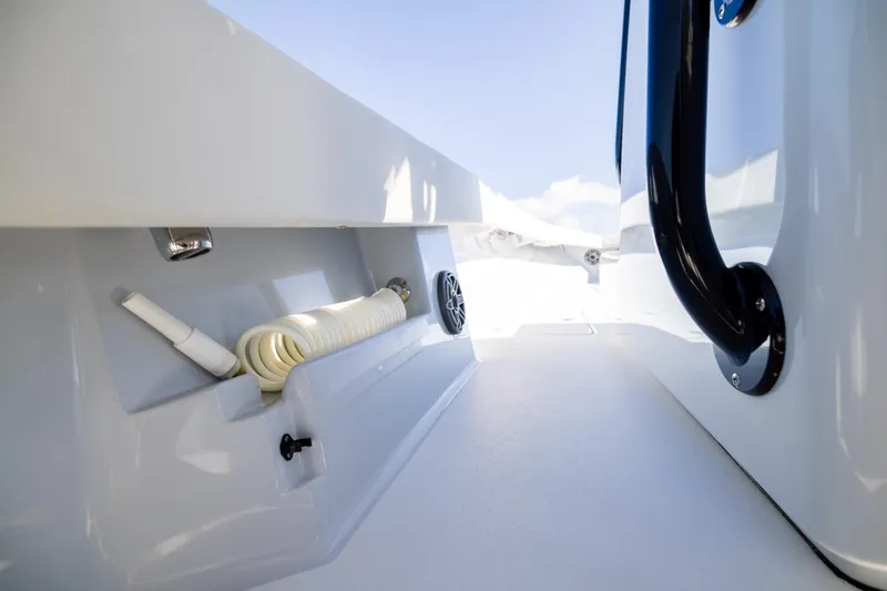  Yacht Photos Pics Interior view of 2025 Conch 33 boat, featuring storage compartment and handle.
