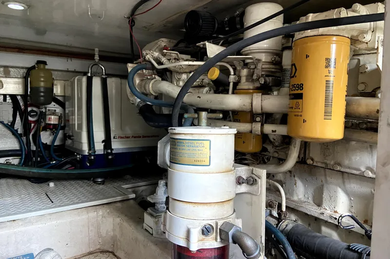 Belle La Vie Sur La Mer Yacht Photos Pics Engine room of 2001 Egg Harbor 37 Convertible with visible fuel and filtration systems.