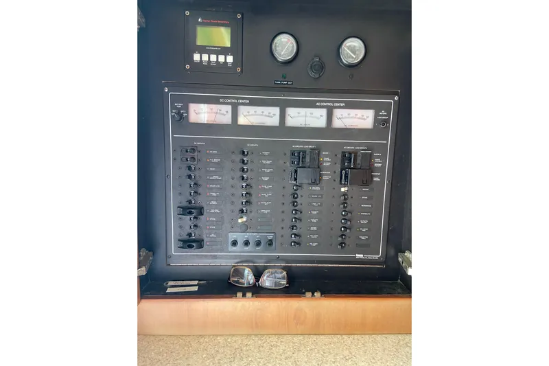 Belle La Vie Sur La Mer Yacht Photos Pics Electrical control panel of 2001 Egg Harbor 37 Convertible boat, featuring gauges and switches.