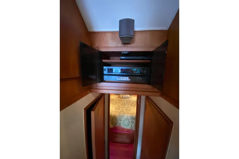 Belle La Vie Sur La Mer Yacht Photos Pics Entertainment system inside 2001 Egg Harbor 37 Convertible yacht, featuring wooden cabinetry.