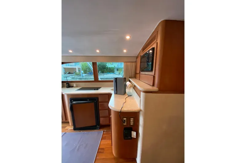 Belle La Vie Sur La Mer Yacht Photos Pics Interior of 2001 Egg Harbor 37 Convertible yacht with kitchenette and wood accents.