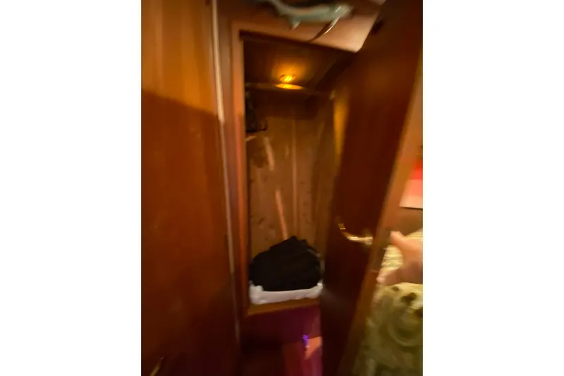 Belle La Vie Sur La Mer Yacht Photos Pics Interior view of a 2001 Egg Harbor 37 Convertible yacht closet with wooden finish.