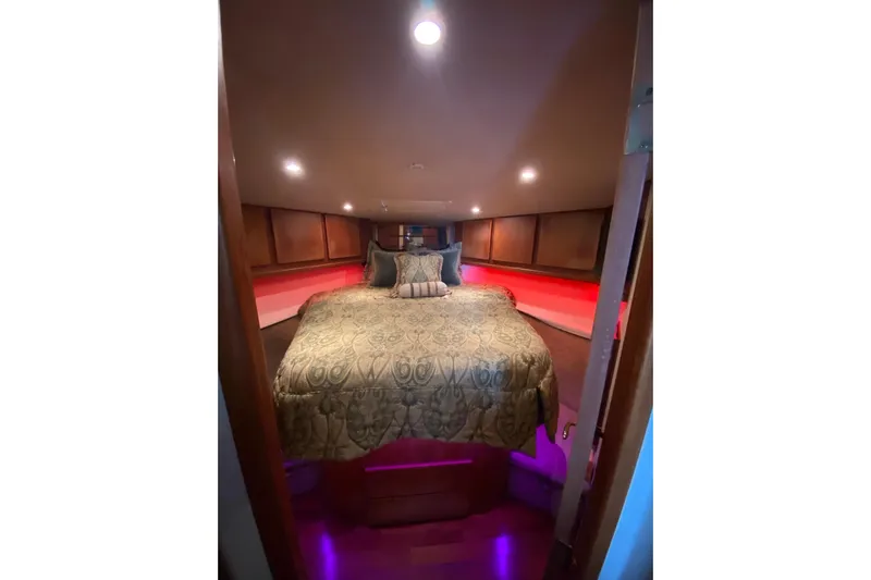 Belle La Vie Sur La Mer Yacht Photos Pics Luxurious bedroom interior of 2001 Egg Harbor 37 Convertible yacht with elegant bedding.