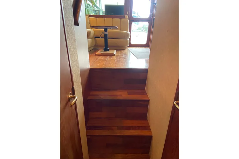 Belle La Vie Sur La Mer Yacht Photos Pics Interior view of 2001 Egg Harbor 37 Convertible yacht with wooden stairs and seating area.