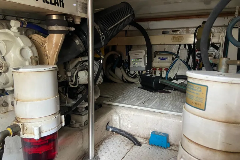 Belle La Vie Sur La Mer Yacht Photos Pics Engine room of a 2001 Egg Harbor 37 Convertible boat, showcasing mechanical components.