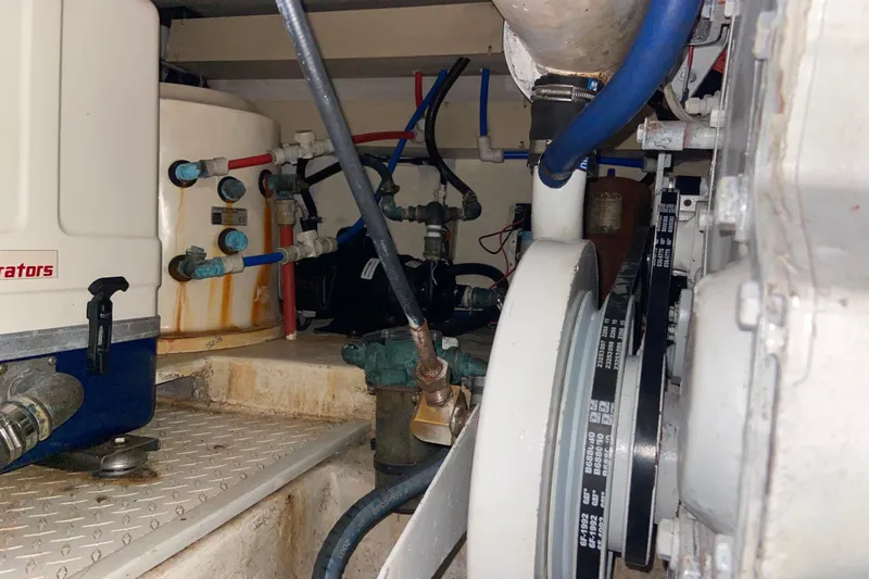 Belle La Vie Sur La Mer Yacht Photos Pics Engine room of 2001 Egg Harbor 37 Convertible with visible machinery and piping.