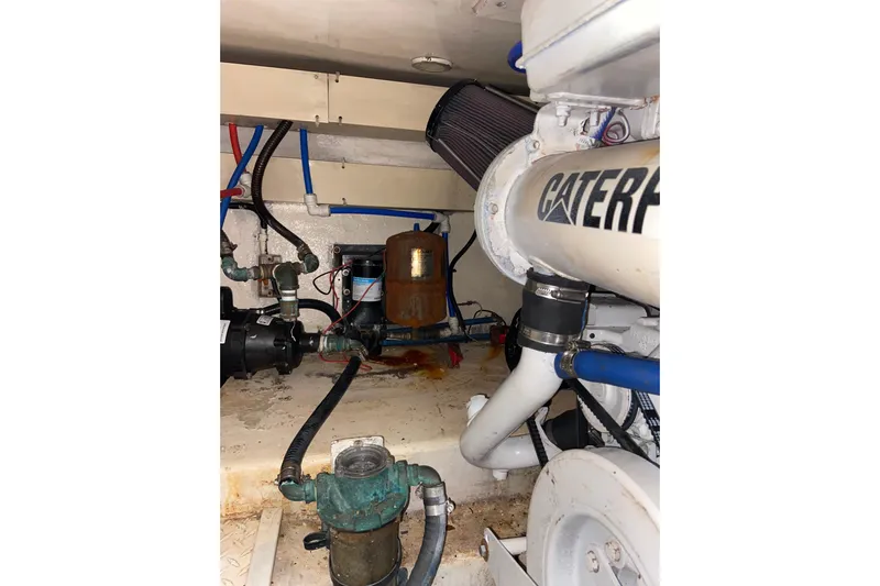 Belle La Vie Sur La Mer Yacht Photos Pics Engine room of 2001 Egg Harbor 37 Convertible boat with visible Caterpillar components.