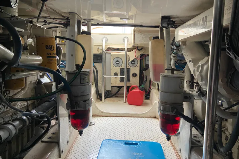 Belle La Vie Sur La Mer Yacht Photos Pics Engine room of a 2001 Egg Harbor 37 Convertible boat, featuring mechanical components and gauges.