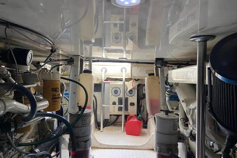 Belle La Vie Sur La Mer Yacht Photos Pics Engine room of 2001 Egg Harbor 37 Convertible boat, showcasing mechanical components and equipment.