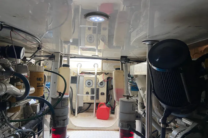 Belle La Vie Sur La Mer Yacht Photos Pics Engine room of a 2001 Egg Harbor 37 Convertible boat, showcasing mechanical components.