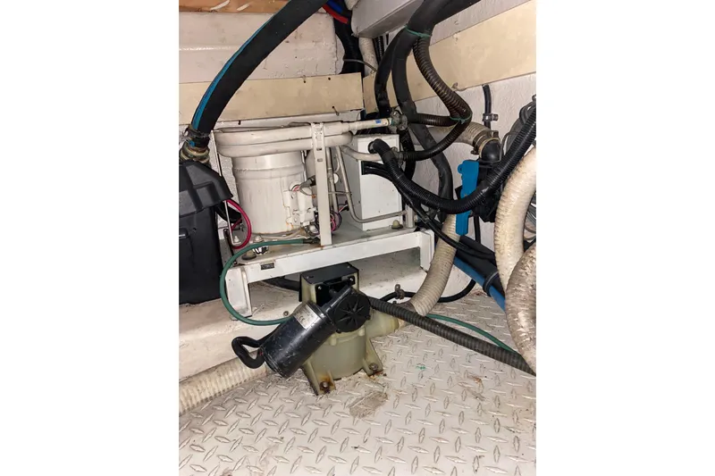 Belle La Vie Sur La Mer Yacht Photos Pics Engine room of 2001 Egg Harbor 37 Convertible with visible hoses and machinery.