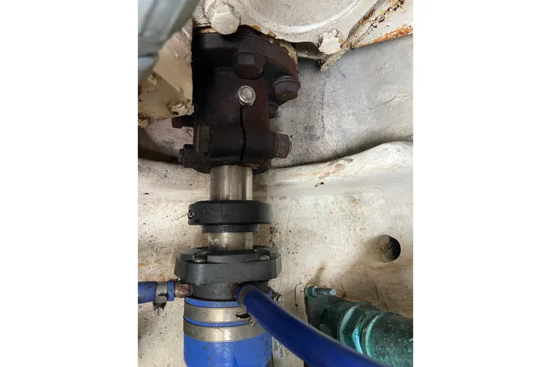 Belle La Vie Sur La Mer Yacht Photos Pics Engine component of 2001 Egg Harbor 37 Convertible boat, featuring metal and blue hose.