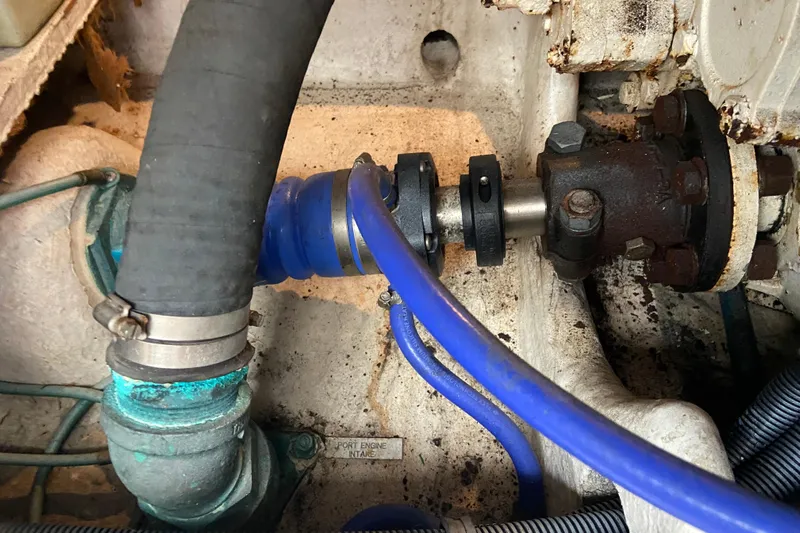 Belle La Vie Sur La Mer Yacht Photos Pics Engine compartment of a 2001 Egg Harbor 37 Convertible boat, showing hoses and mechanical components.