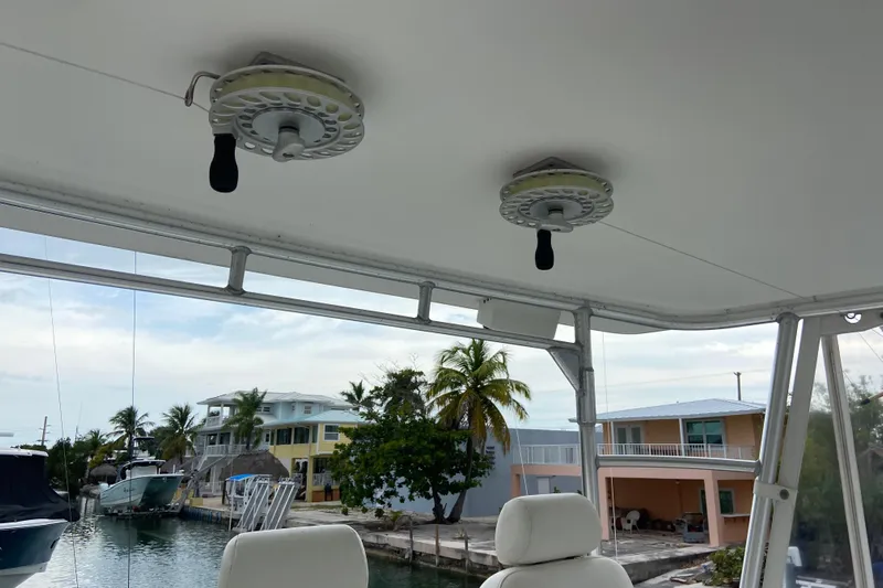 Belle La Vie Sur La Mer Yacht Photos Pics 2001 Egg Harbor 37 Convertible boat interior with fishing reels, dockside view.