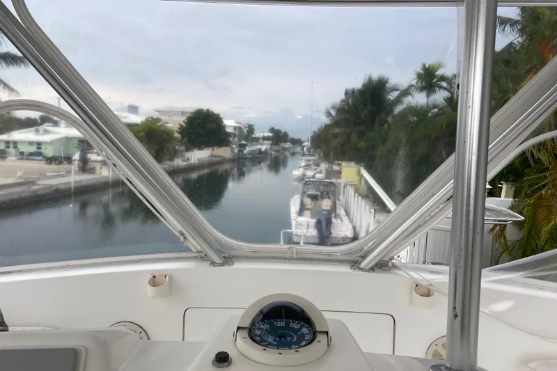 Belle La Vie Sur La Mer Yacht Photos Pics View from 2001 Egg Harbor 37 Convertible boat, overlooking a serene canal with docked boats.