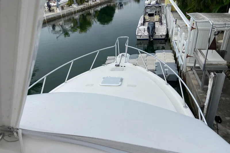 Belle La Vie Sur La Mer Yacht Photos Pics Bow view of 2001 Egg Harbor 37 Convertible docked in a marina.