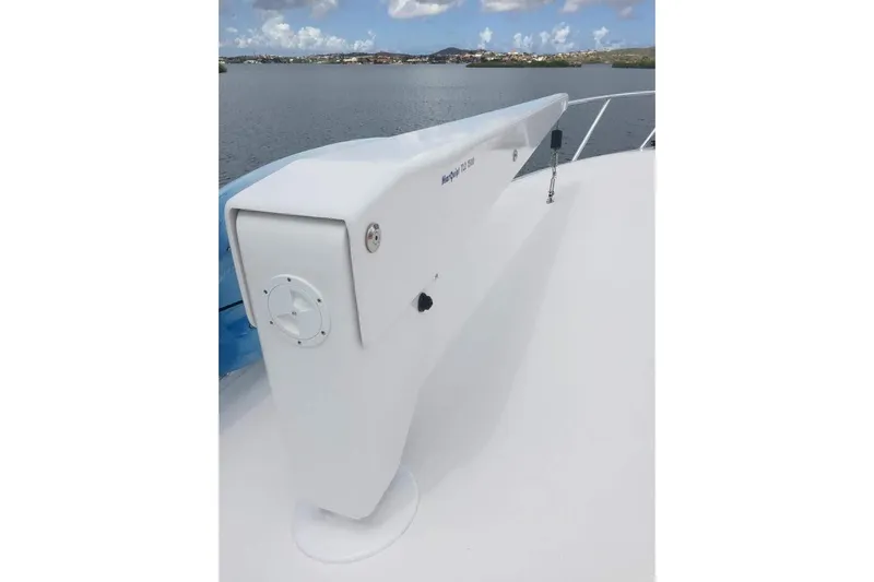 Caraibi Yacht Photos Pics 2013 Hatteras GT63 yacht deck with a white anchor winch, overlooking calm waters.