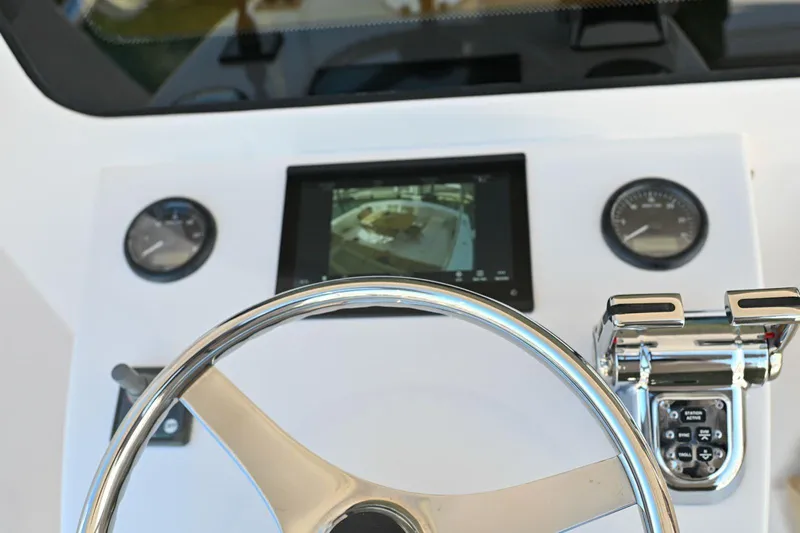 Caraibi Yacht Photos Pics Steering console of 2013 Hatteras GT63 yacht with gauges and display screen.