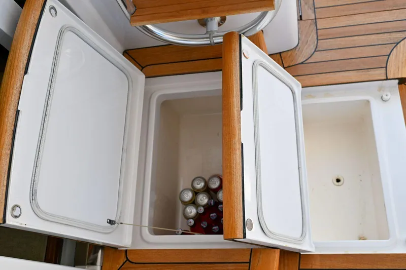 Caraibi Yacht Photos Pics Open storage compartments on 2013 Hatteras GT63 yacht deck with canned drinks inside.