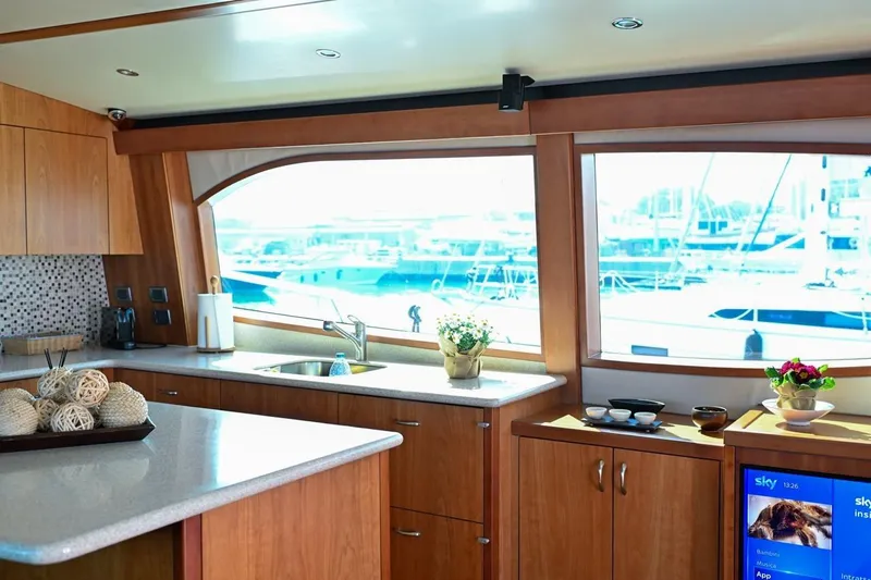 Caraibi Yacht Photos Pics Luxurious 2013 Hatteras GT63 yacht interior with modern kitchen and marina view.