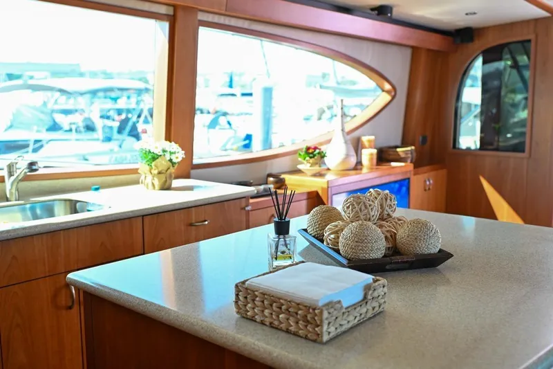 Caraibi Yacht Photos Pics Luxurious interior of 2013 Hatteras GT63 yacht with elegant decor and large windows.