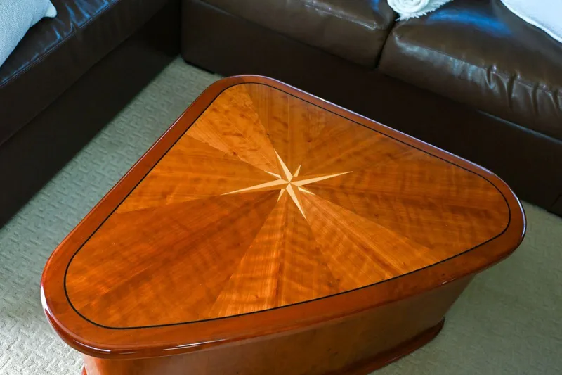 Caraibi Yacht Photos Pics Elegant wooden table with starburst design on a Hatteras GT63 yacht, 2013 model.