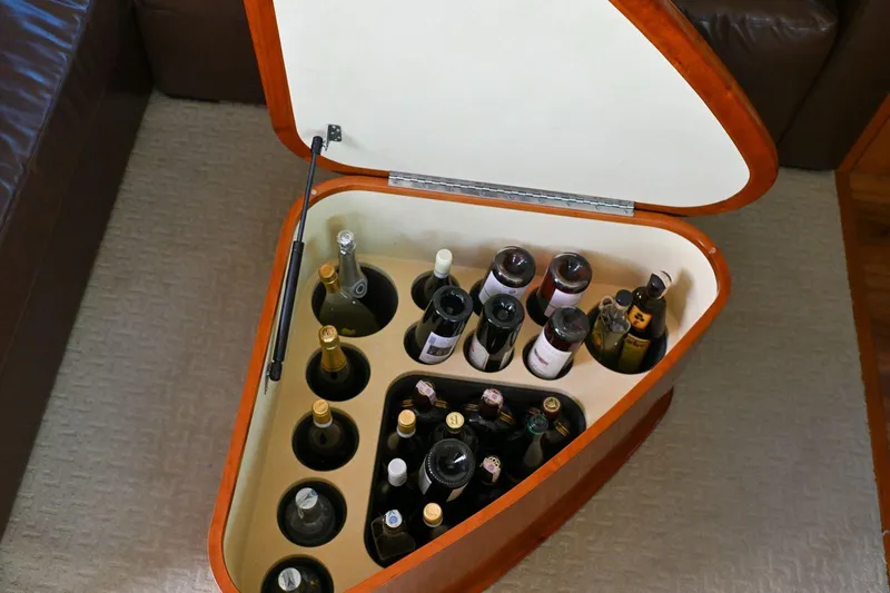 Caraibi Yacht Photos Pics Luxury yacht Hatteras GT63 2013 wine storage compartment with assorted bottles.