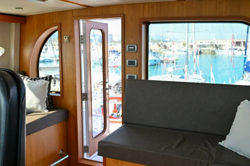 Caraibi Yacht Photos Pics Interior of 2013 Hatteras GT63 yacht with marina view through windows.
