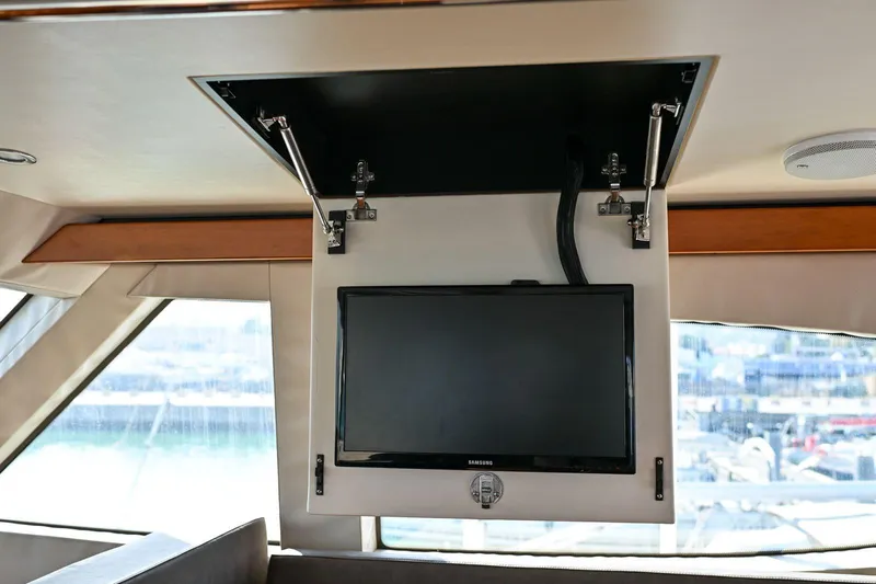 Caraibi Yacht Photos Pics Ceiling-mounted TV in 2013 Hatteras GT63 yacht interior.