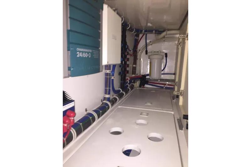 Caraibi Yacht Photos Pics Engine room of 2013 Hatteras GT63 yacht with visible wiring and equipment.