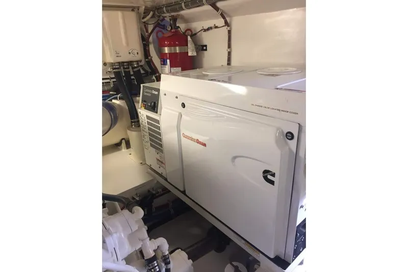 Caraibi Yacht Photos Pics Engine room of 2013 Hatteras GT63 yacht featuring Cummins Onan generator.