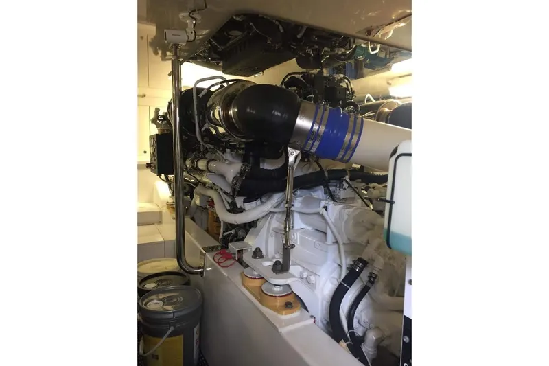 Caraibi Yacht Photos Pics Engine room of 2013 Hatteras GT63 yacht, showcasing complex machinery and components.