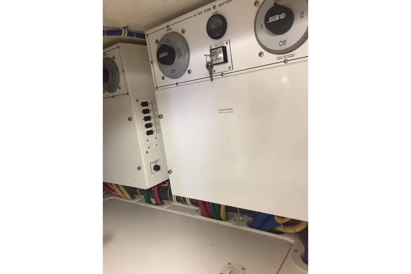 Caraibi Yacht Photos Pics Electrical panel of a 2013 Hatteras GT63 yacht, featuring switches and wiring.